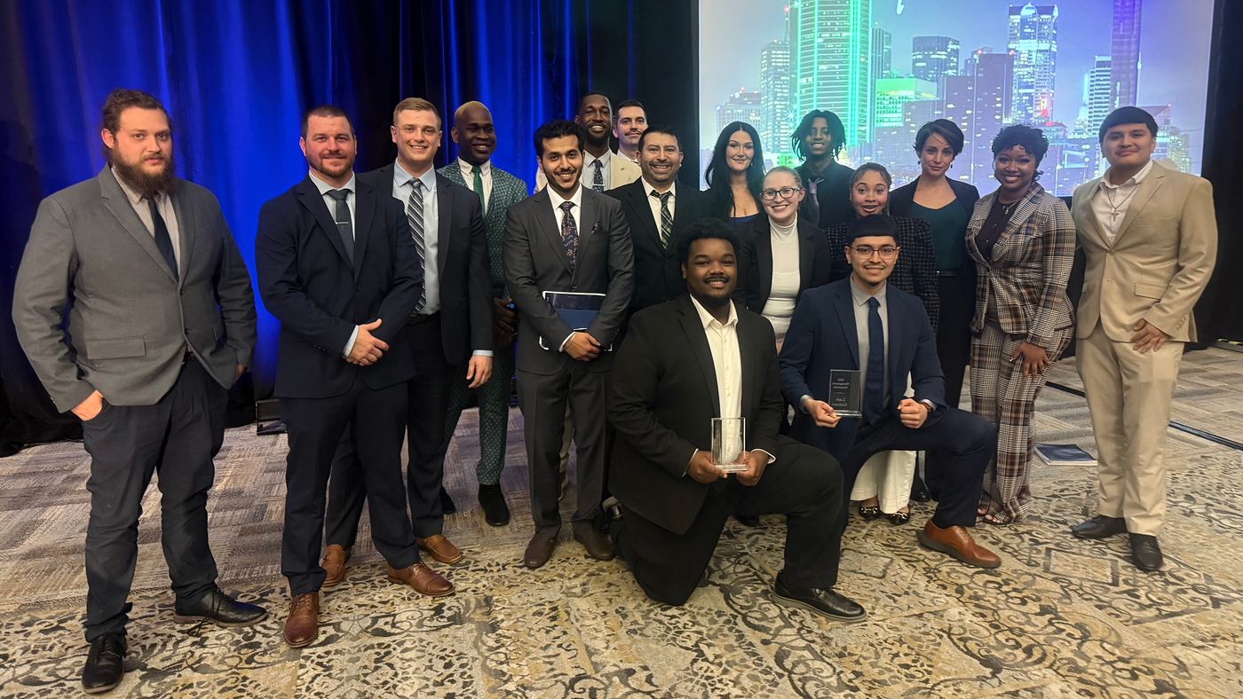 The Feather and Scale Marketing team on stage with their awards at the Dallas Regional Meeting
