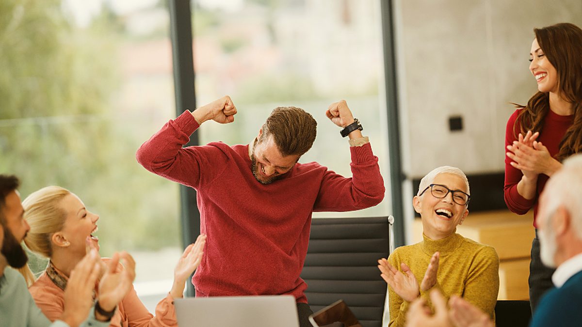 A marketing team celebrating a campaign result together in the office